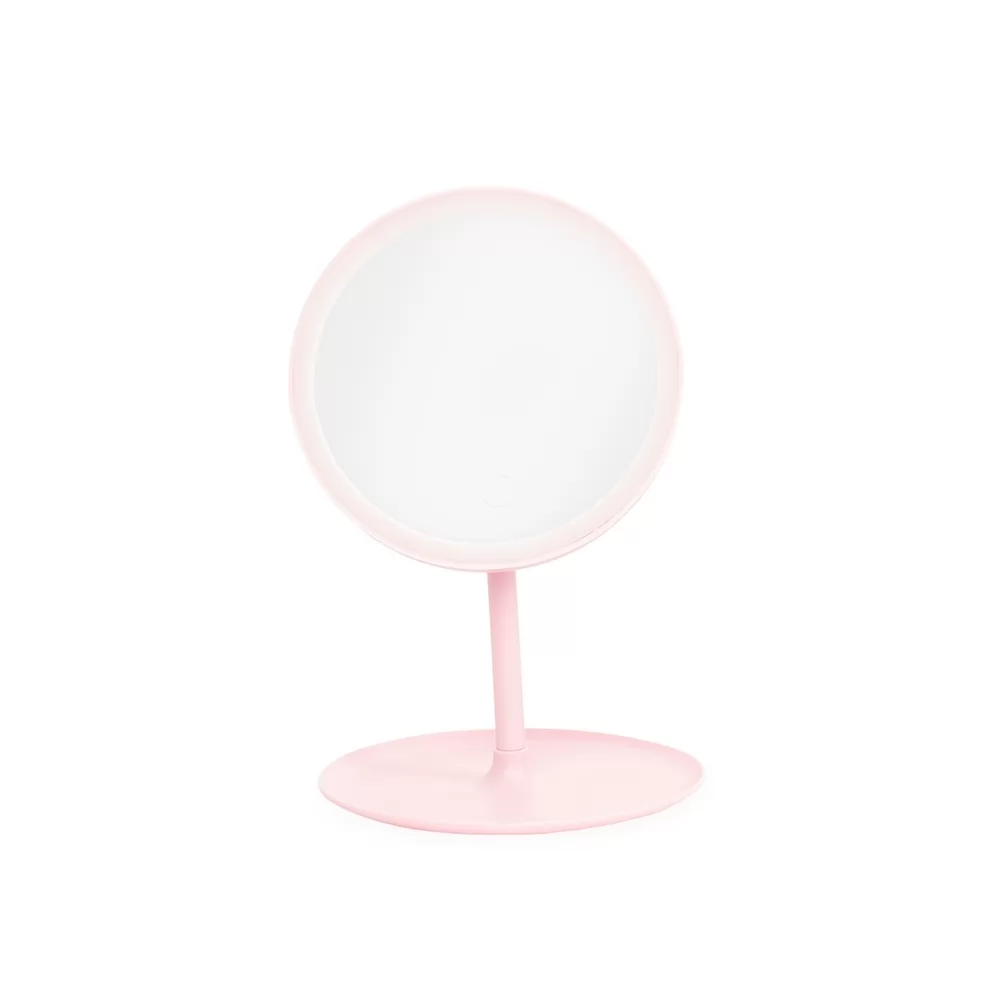 Espelho de mesa plástico rosa com LED e base redonda visto de frente sobre fundo branco